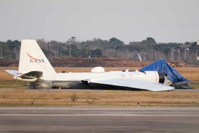 NASA Research Plane Slides In on Its Belly in Houston