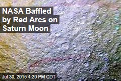 NASA Baffled by Red Arcs on Saturn Moon