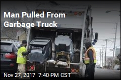 Fighterfighters Rescue Man From Garbage Truck