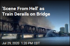 &#39;Scene From Hell&#39; as Train Derails on Bridge