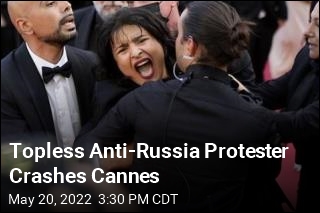 Topless Anti-Russia Protester Crashes Cannes