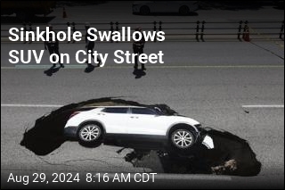 Sinkhole Swallows SUV on City Street