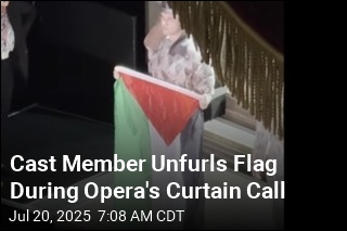 Cast Member Unfurls Flag During Opera&#39;s Curtain Call