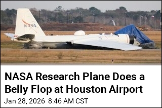 NASA Research Plane Slides In on Its Belly in Houston