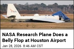 NASA Research Plane Slides In on Its Belly in Houston